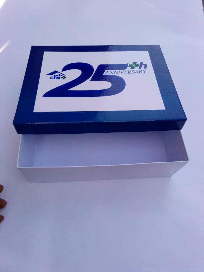 Chi — 25th Anniversary rigid gift box, foil-blue lid with a white base tray.