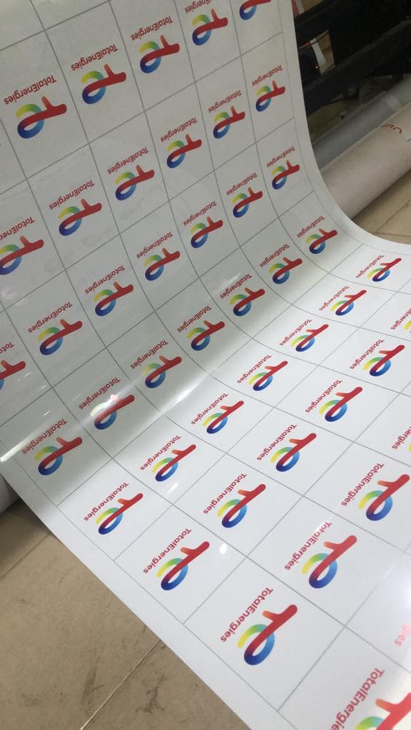 TotalEnergies — Decals coming off the roll, reverse-printed for application.