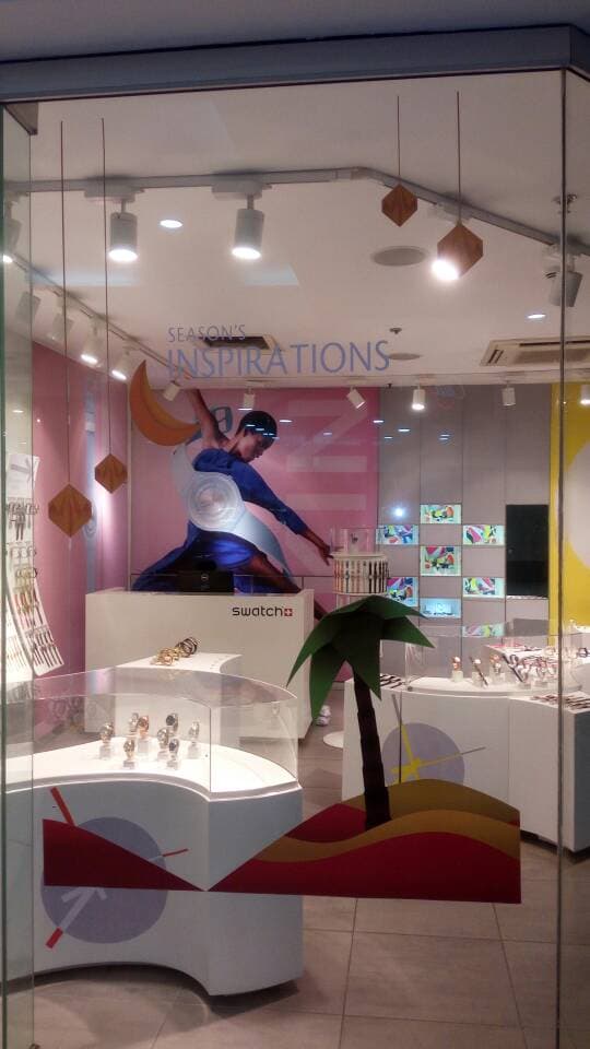 Swatch — Store fit-out — window graphics, display plinths and a die-cut prop.